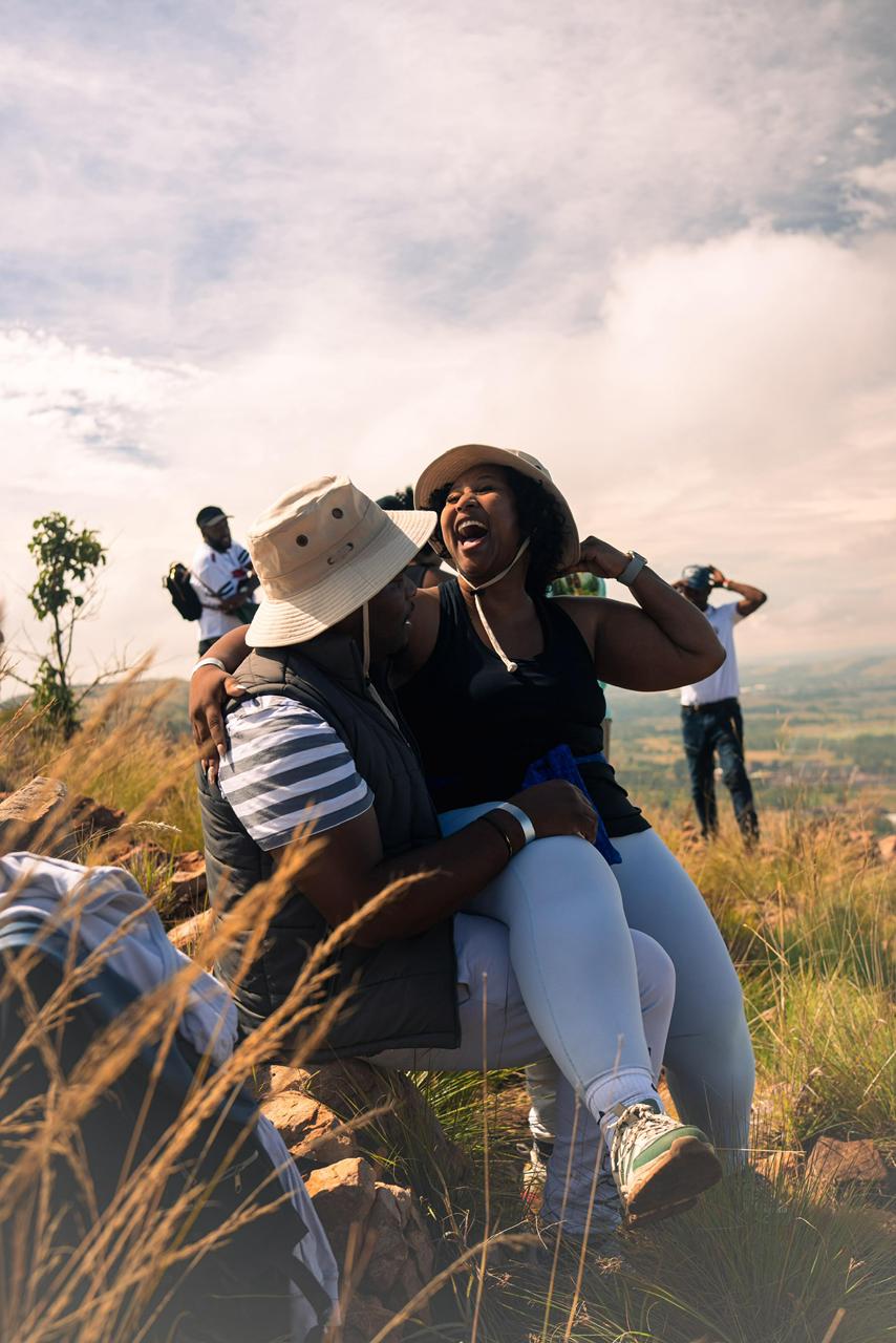 A couple sharing a joyful moment on a mountain summit